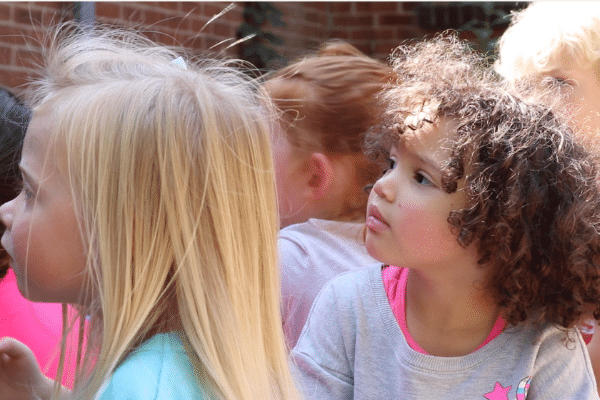 Preschool student listening to a speaker