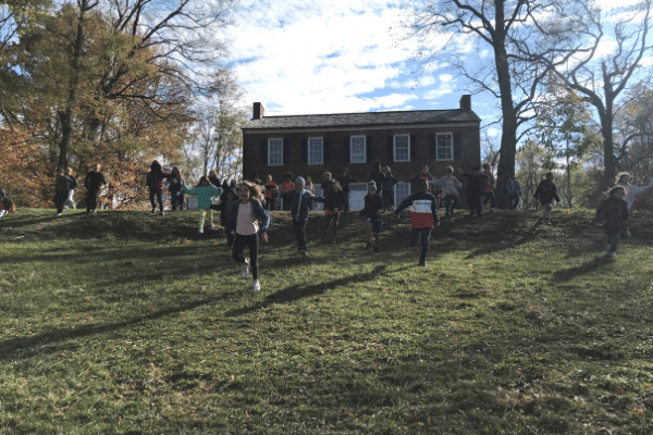Students running down the hill at Conner House