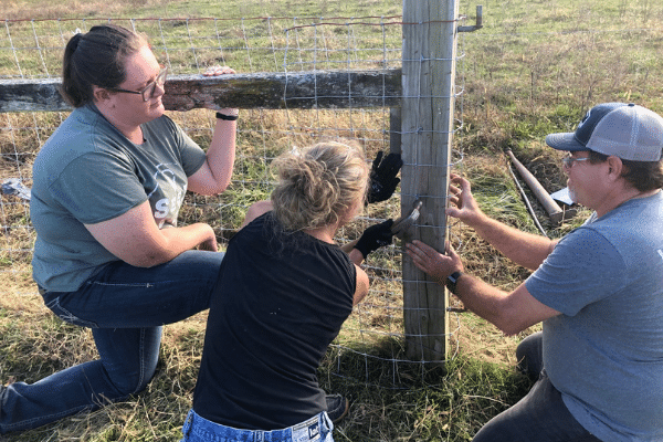 Ag staff working on fence