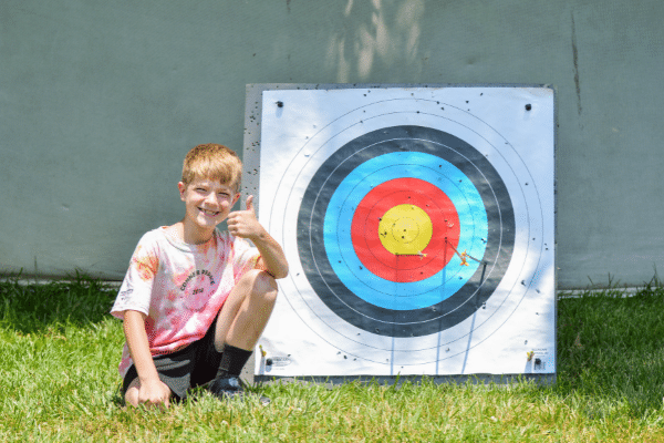 Camper showing off his archery target