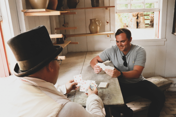 History on Tap guest playing cards with a Conner Prairie interpreter
