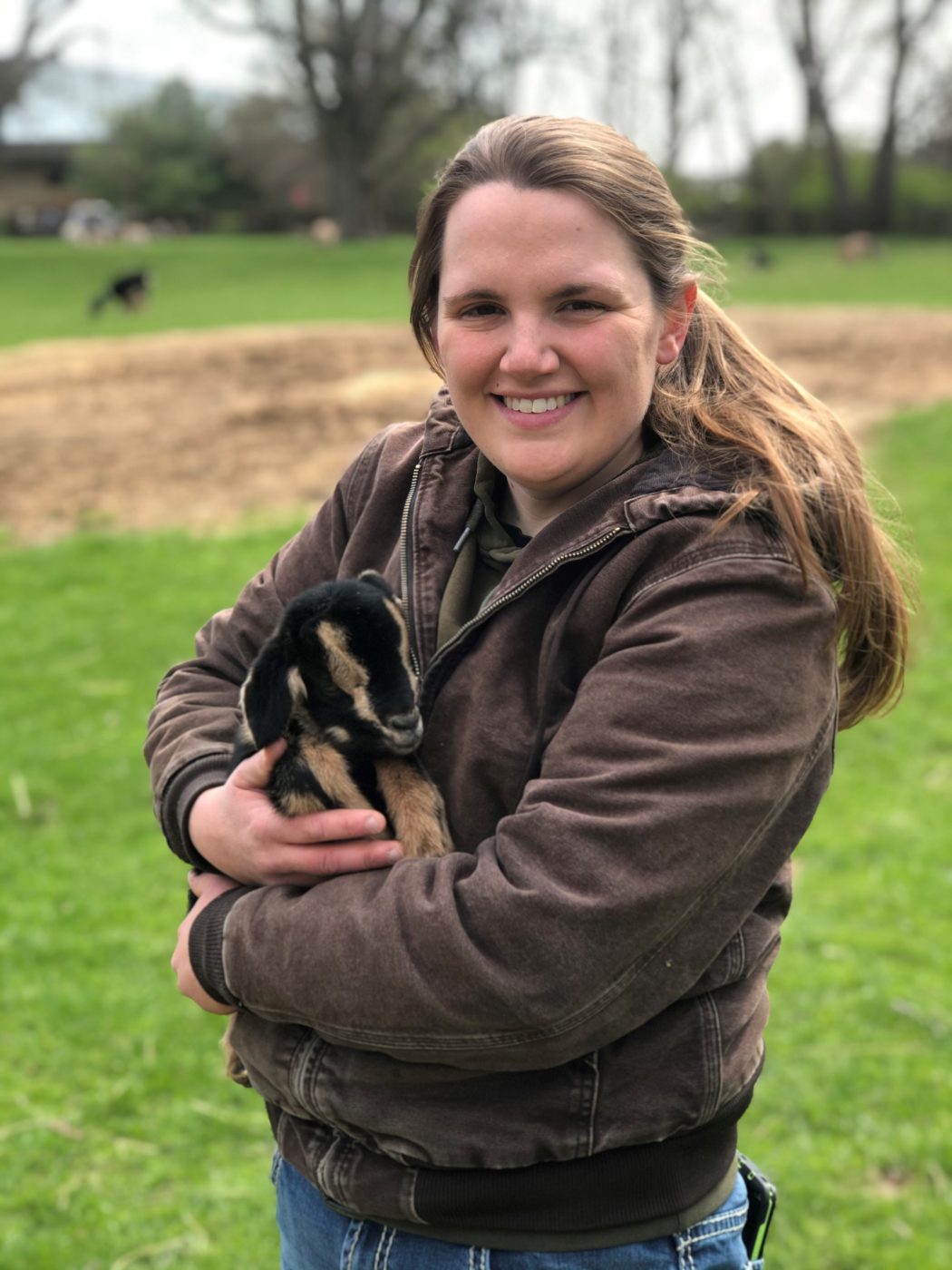 Stephanie Buchanan, Animal Encounters Manager at Conner Prairie, holding a baby goat