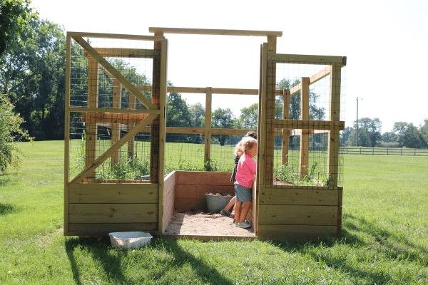 Two children learning outdoors at Preschool on the Prairie Garden