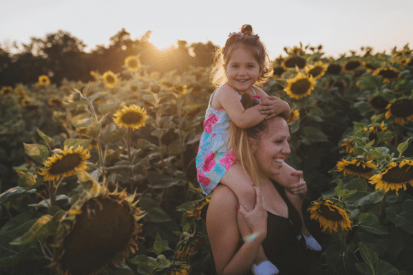 Mom And Daughter In Sunflower Fields
