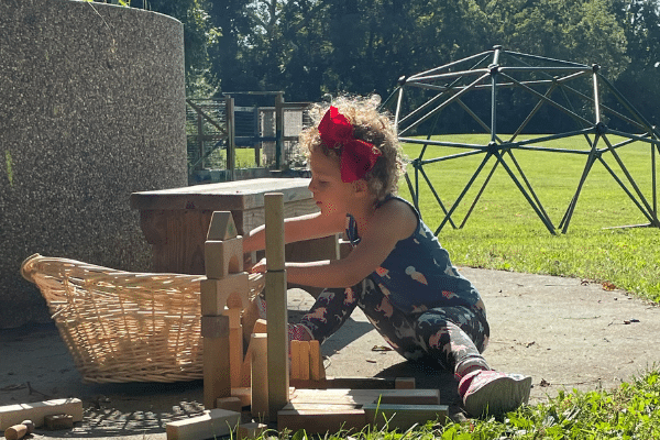 Little Girl Building With Wooden Blocks