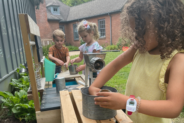 Preschool Students Playing In Pretend Kitchen