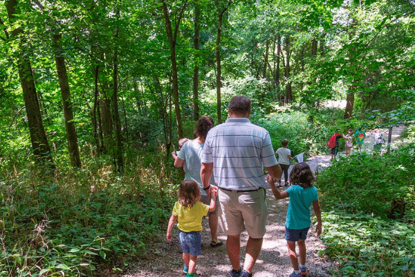 Family walking the trails at Conner Prairie