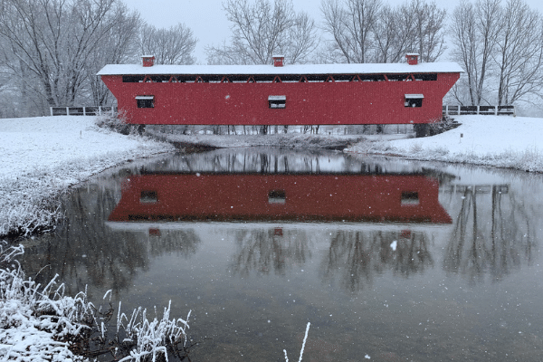 Red covered bridge in snowfall