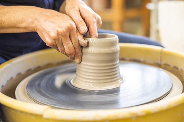 Person working on pottery
