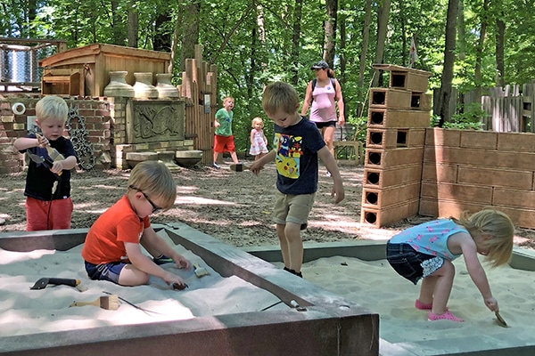 children in the sand at treetop outpost
