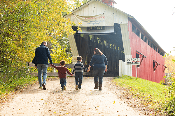 family of four at the covered bridge