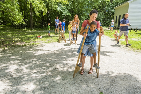 Family playing with the wooden stilts