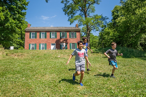 children running on hill at william conner house