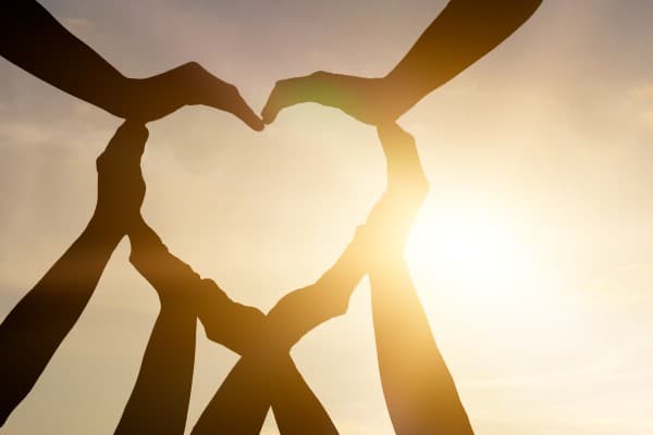 People making a heart with their hands