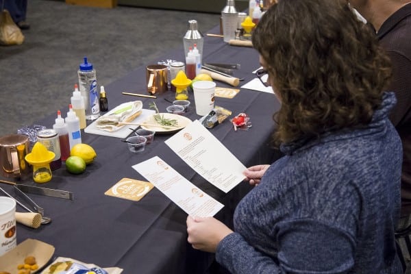 Woman reading cocktail recipe