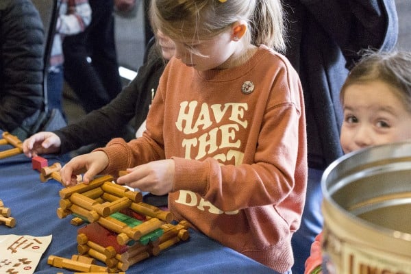 Kid playing with Lincoln Logs at Presidents Day