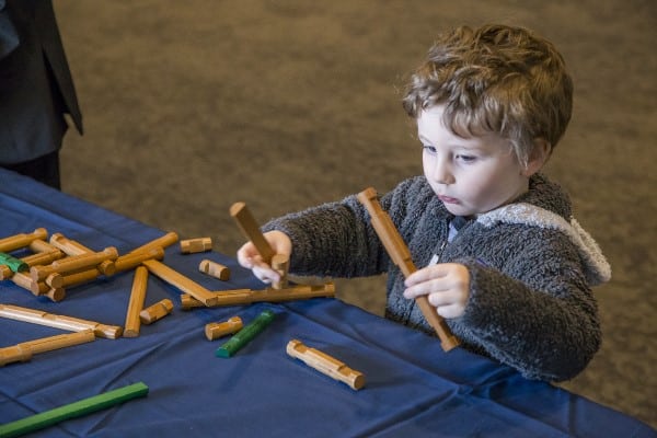Child playing with Lincoln Logs