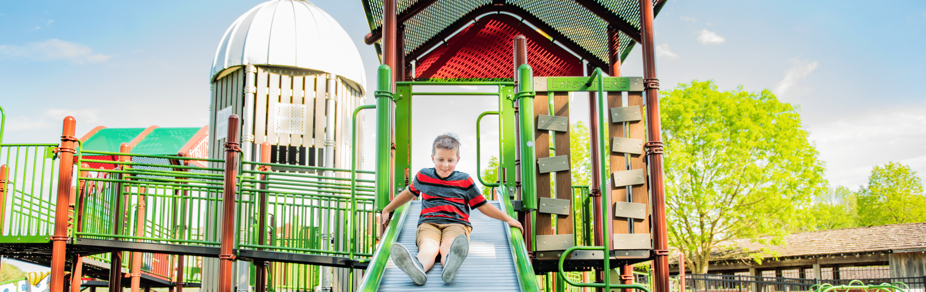 Boy going down a slide at Ag Adventures park