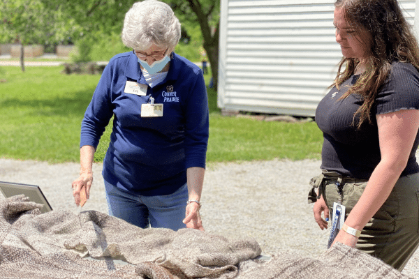 Conner Prairie staff talking about scarf made from Tunis sheep wool