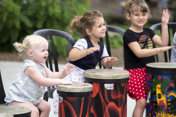 Children participating in a drum circle