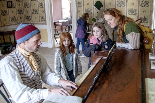 Prairietown man entertaining guests by playing the piano