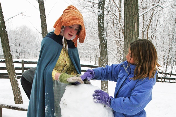 Interpreter and a guest making a snowman