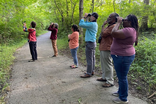 Picture1 Six individuals using binoculars on a trail