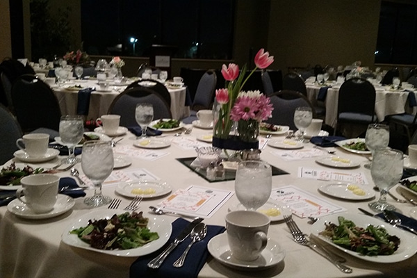 table set with flowers and a salad