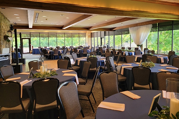 tables set up inside of a building with a lot of windows