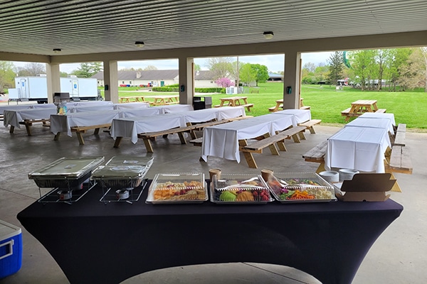 picnic tables and a buffet inside of a shelter