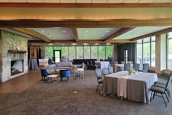tables set up in a room with windows