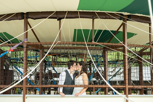 Bride and groom kissing in the balloon gondola