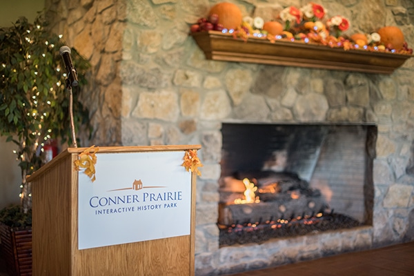 fireplace and podium that says Conner Prairie
