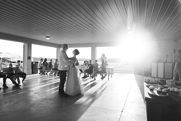 black and white image of a bride and groom dancing