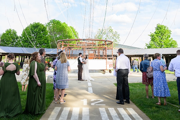 wedding party observing bride and groom standing in front of gondola