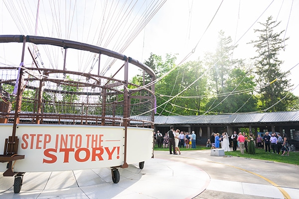 Wedding party standing near balloon gondola