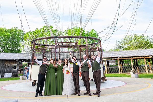 Wedding party standing in front of balloon gondola