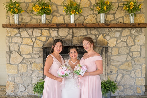 wedding party standing in front of a fire place