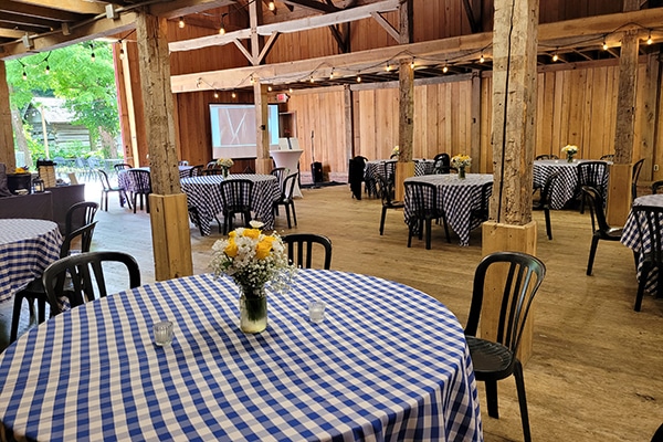 tables set up inside of wooden building