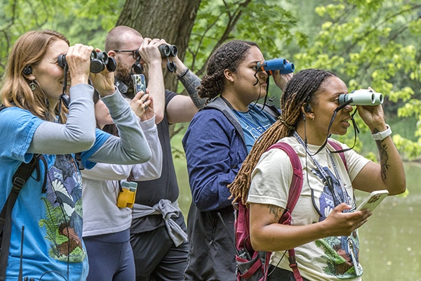 A group bird watching on the Trails at Conner Prairie.