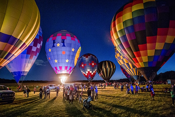 Hot air balloons at night during Jupiter Flights Balloon Festival.