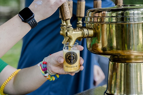 Person pouring beer at History on Tap.