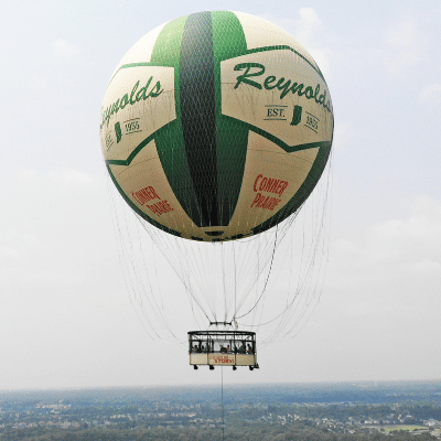 Aerial shot of new, green and white hot air balloon
